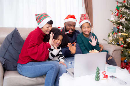 Happiness African family on sofa video call on laptop computer together in the living room at home...