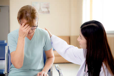 Doctor woman encourage patient senior while worry and stress for reassuring at hospital, physician...