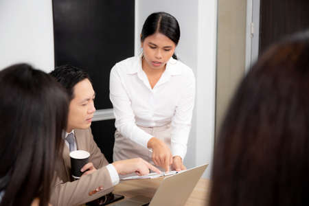Team asian business group meeting conference about marketing and finance with ceo at the office, secretary report financial with manager or boss for planning strategy, indoor, business concept.の写真素材