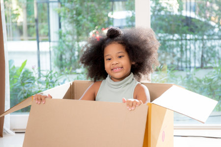 Happiness African children hiding inside box with playful and excitement, child leisure and relax in...