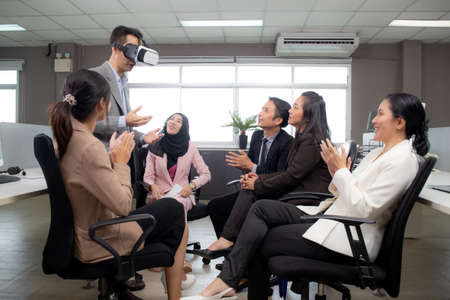 Young businessman is developer design testing of connection metaverse on vr realistic in the office, development global of engineer for creative application with collaboration, business concept.の写真素材