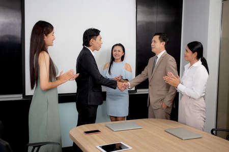 Businessman or manager shaking hands with partnership for agreement together of business at the office, boss meeting conference with employee and partner about deal for collaboration with success.の写真素材