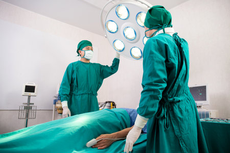 Doctor and surgeon preparation with rescue and  save patient in the operation room at hospital, surgery and emergency, medical and technology, surgical and health, specialist and assistant.の写真素材