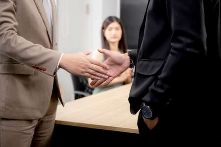 Businessman or manager shaking hands with partnership for agreement together of business at the office, boss meeting conference with employee and partner about deal for collaboration with success.の写真素材