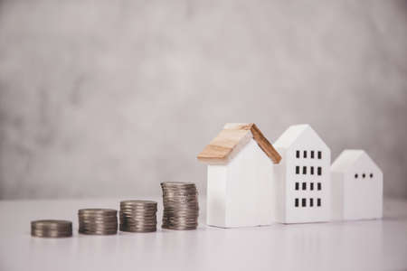 Stack of coin with revenue and saving money for real estate and success, finance and investment,...