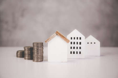 Stack of coin with revenue and saving money for real estate and success, finance and investment, insurance home, deposit and property and financial, residential and refinance, business concept.の写真素材