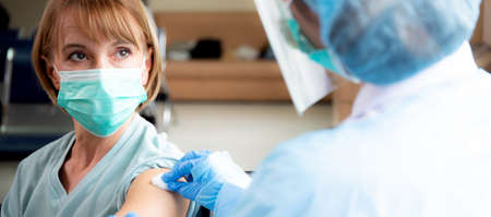 Doctor woman preparing vaccine for female patient