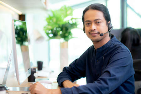 Customer service with friendly, businessman is call center and operator for support client, assistance and consultant, adviser helpdesk and contact, man wearing headset, business concept.の写真素材