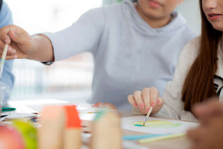 Closeup group of student sitting and studying and learning drawing with teacher together in...