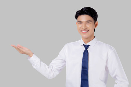 Portrait young asian business man presenting isolated on white background, advertising and marketing, executive and manager, businessman confident showing success, expression and emotion.の写真素材