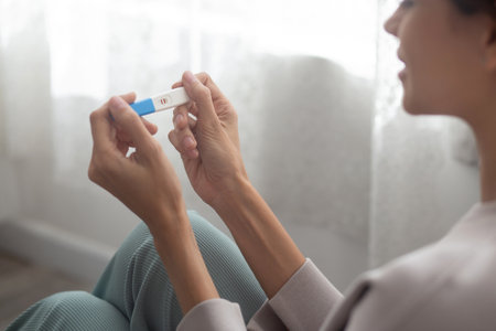 Happiness young woman taking pregnancy test while excited and satisfied in the bedroom at home, happy mother with smile and expression with love, ovulation and maternity, medical concept.の写真素材