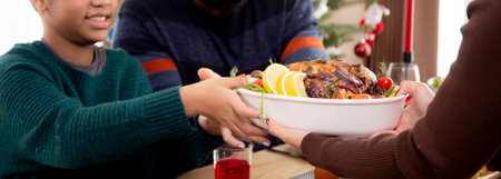 Happy family with mother served roasted turkey on Christmas holiday at home, thanksgiving eve, woman preparing food for celebrating and dinner with family, festive xmas and new year.の写真素材