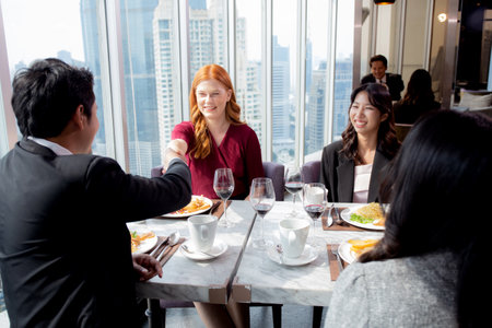 Happy team young business people in party celebrate success talking and introduce friends together with enjoyment at restaurant, friendly and social colleague, meet friend and community concept.の写真素材