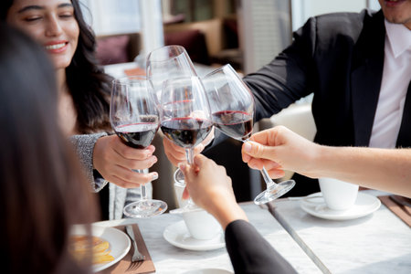 Happiness team young business people in party celebrate success holding glass of wine cheer together at restaurant luxury, friendly and social colleague, meet friend and community concept.の写真素材