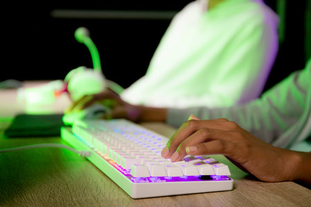 Closeup hands of woman play video game and live streaming online with computer desktop at home,...