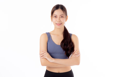Portrait of beautiful young asian woman in sportwear smile and crossed arms isolated on white background, sport and exercise for health and weightloss, female and slimming with confident and wellness.の写真素材