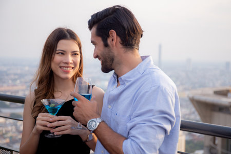 Couple drinking cocktail with romance at restaurant luxury for celebrate with enjoyment together, happy man and woman dating meeting with romantic and drinking beverages, lifestyles concept.の写真素材