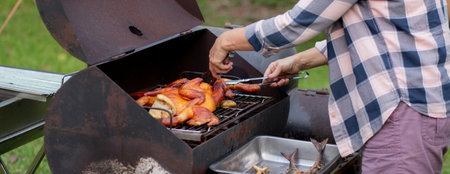 Senior woman grilling chicken meat for preparing eat in camping, elderly doing activity recreation and leisure picnic while roasting meat in weekend, travel trip in holiday, party in vacations.の写真素材