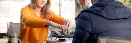 Two senior woman and teenager talking and leisure in camping, activity recreation and leisure picnic while breakfast together in morning in weekend, travel trip in holiday, party in vacations.の写真素材