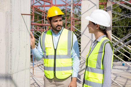 Young architect man and woman talking for planning about development real estate and house at...