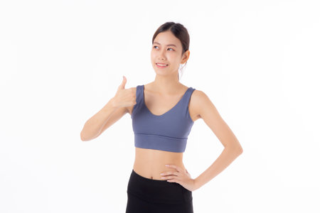 Portrait beautiful young asian woman in sportwear smile and thumbs up isolated on white background, sport and training exercise for health, female fitness workout for slimming and confident.の写真素材