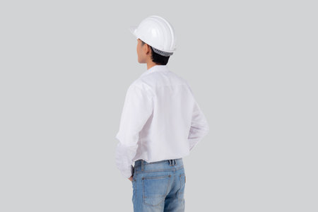 Portrait young engineer asian man wearing helmet standing isolated on white background, handsome...