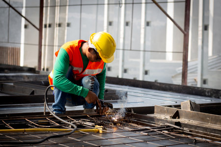 Young asian worker using machine welding iron with hands working in industrial factory, welder man...