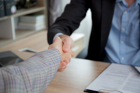 Young asian businesswoman job interview with caucasian manager and agreement with handshake at office, hr director interview with recruitment personnel and shaking hands, manager and partner.の写真素材
