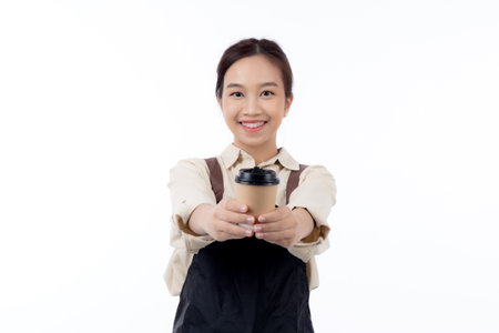 Portrait of young asian barista woman wearing apron giving coffee cup isolated white background, waitress or entrepreneur holding coffee with excited, small business or startup, waiter of cafe.の写真素材