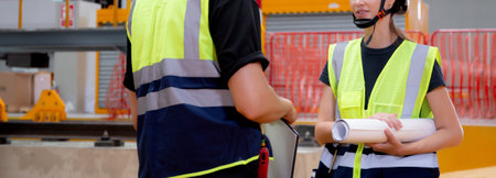 Young caucasian engineer man and woman meeting and checking electric train for planning maintenance in station, transport and infrastructure, inspector talking and check service transport.の写真素材