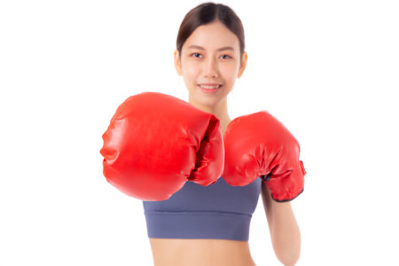 Portrait beautiful young asian woman in sportswear exercise with boxing sport isolated white background, woman training workout with punch for healthcare, health and bodycare, power and strong.の写真素材