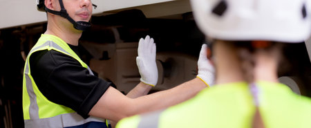 Young caucasian engineer man and woman meeting and checking electric train for planning maintenance in station, transport and infrastructure, inspector talking and check service transport.の写真素材