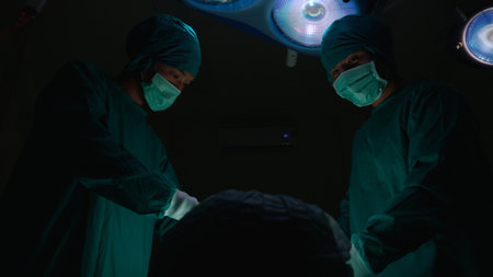 Group of team doctor and surgeon doing surgery with patient in the operation at hospital, medical and emergency, specialist and assistant rescue patient with expertise, surgical and health.の写真素材