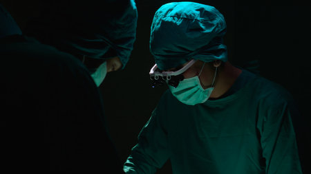 Group of team doctor and surgeon doing surgery with patient in the operation at hospital, medical and emergency, specialist and assistant rescue patient with expertise, surgical and health.の写真素材