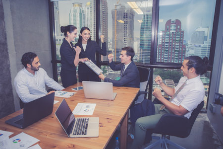 Group of young business team with woman manager standing leader present profit meeting in conference room at modern coworkers office, teamwork and business concept.の写真素材