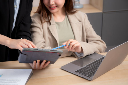 Two young business woman working together about project for success in modern office, businesswoman...
