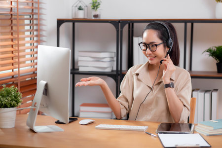 Professional young asian business woman working and meeting online in modern home office, businesswoman video call with conference distant, call center and support, consulting with business.の写真素材