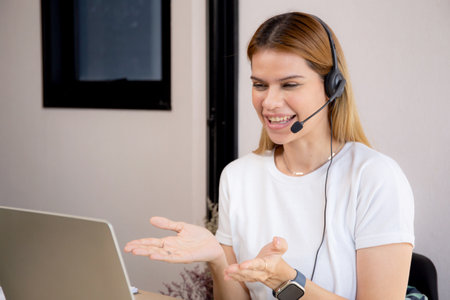 Professional young business woman working and meeting online in modern home office, businesswoman video call with conference distant, call center and support, consulting with business.の写真素材