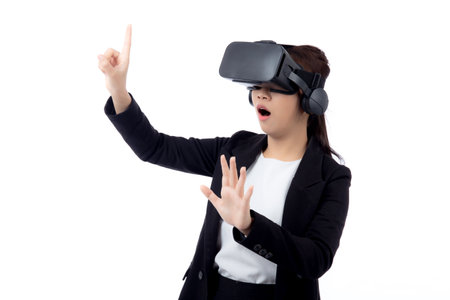 Portrait young asian businesswoman wearing headset virtual reality for device with experience and entertainment with interactive isolated white background, simulation and innovation with business.の写真素材