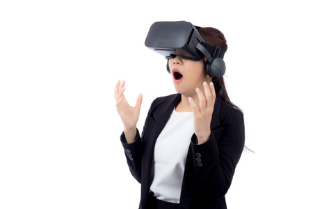 Portrait young asian businesswoman wearing headset virtual reality for device with experience and entertainment with interactive isolated white background, simulation and innovation with business.の写真素材