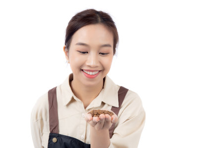 Portrait young asian barista woman wearing apron holding beans coffee isolated white background, waitress or entrepreneur cheerful, small business or startup, waiter of cafe or coffee shop.の写真素材