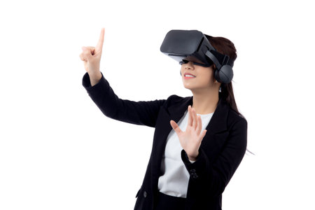 Portrait young asian businesswoman wearing headset virtual reality for device with experience and entertainment with interactive isolated white background, simulation and innovation with business.の写真素材