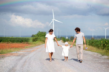 Family with daughter, father and mother walking on nature, kid and parent relax and leisure together, happy family bond with smiling, travel on vacation in summer together, family concept.の写真素材