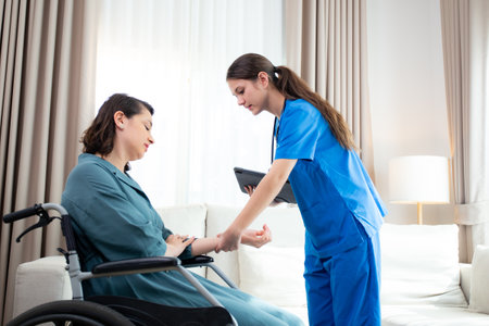 Caregiver checkup and diagnostic leg and knee of woman patient about arthritis while sitting on wheelchair at home, caretaker explaining and examining patient with tablet.の写真素材