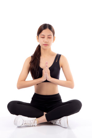 Portrait young asian woman meditating in yoga pose isolated white background, girl workout with yoga for health and wellness, practice yoga for healthy, sport and peaceful, one person, full length.の写真素材