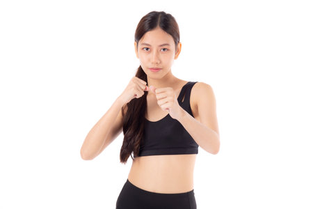 Portrait young asian woman in sportswear exercise with cardio pose while punch isolated white background, girl workout with strength and strong, sport and motivation, determination and endurance.の写真素材