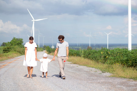 Family with daughter, father and mother walking on nature, kid and parent relax and leisure together, happy family bond with smiling, travel on vacation in summer together, family concept.の写真素材