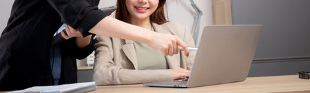 Two young business woman working together about project for success in modern office, businesswoman discussion with consulting for planning and analyzing about marketing, business and strategy.の写真素材