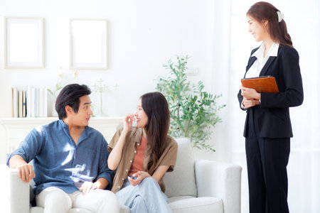 Happy asian couple during visit house from real estate agent after success property purchase home, home ownership and mortgage loan, investment and mortgage, couple consulting with real estate agent.の写真素材