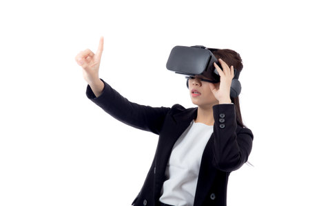Portrait young asian businesswoman wearing headset virtual reality for device with experience and entertainment with interactive isolated white background, simulation and innovation with business.の写真素材